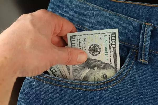 hand-takes-money-dollars-from-pocket